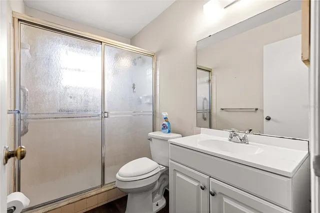 a bathroom with a toilet sink and a mirror