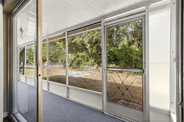 a view of backyard of house with green space
