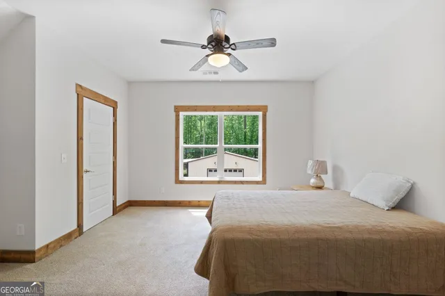a bedroom with a large bed and a window