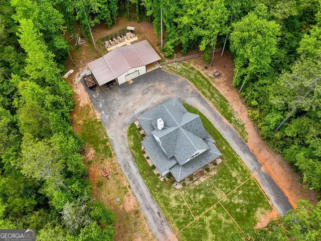 a view of a big house with a big yard and large trees