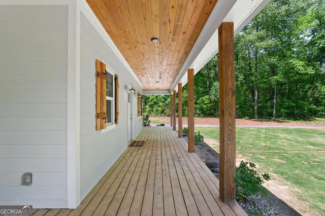 a view of a patio with table and chairs floor to ceiling window with wooden floor
