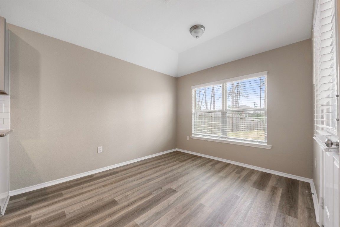 175 Courageous Side Way Magnolia, TX 77354 - Photo 12 of 28 a view of an empty room with wooden floor and a window