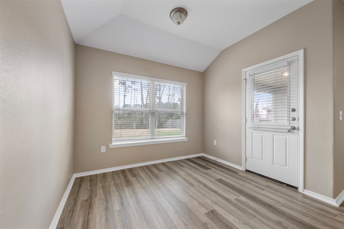 175 Courageous Side Way Magnolia, TX 77354 - Photo 13 of 28 a view of an empty room with wooden floor and a window