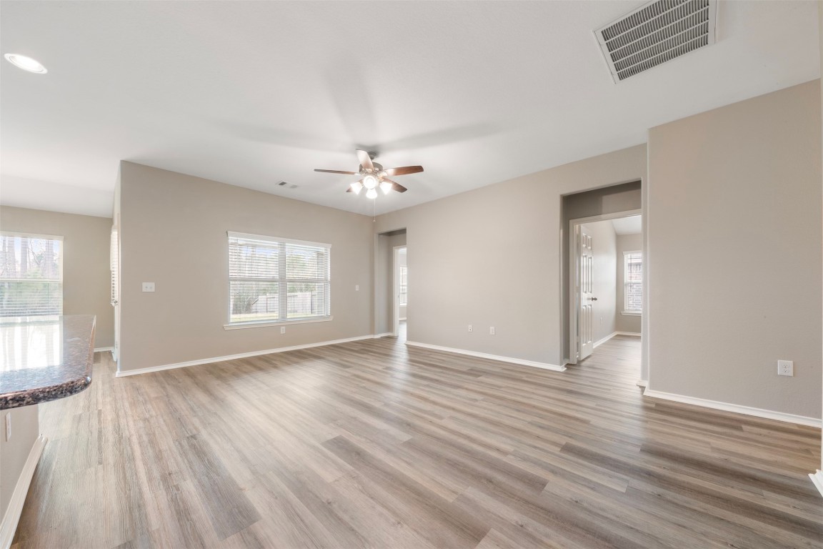 175 Courageous Side Way Magnolia, TX 77354 - Photo 14 of 28 a view of an empty room with wooden floor and a window