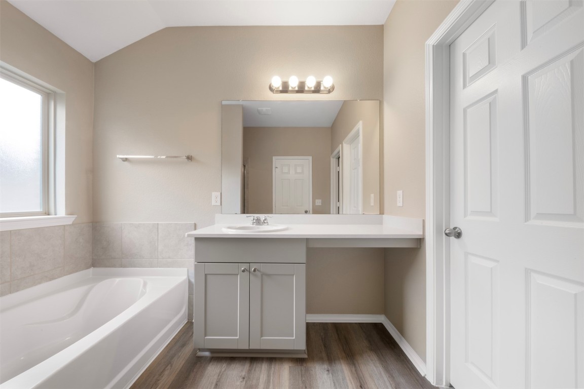 175 Courageous Side Way Magnolia, TX 77354 - Photo 17 of 28 a bathroom with a bathtub a sink and a mirror