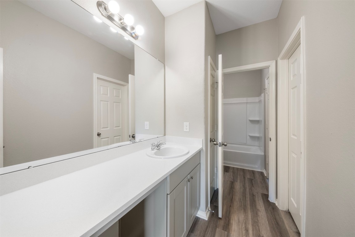 175 Courageous Side Way Magnolia, TX 77354 - Photo 20 of 28 a bathroom with a sink a mirror and a shower