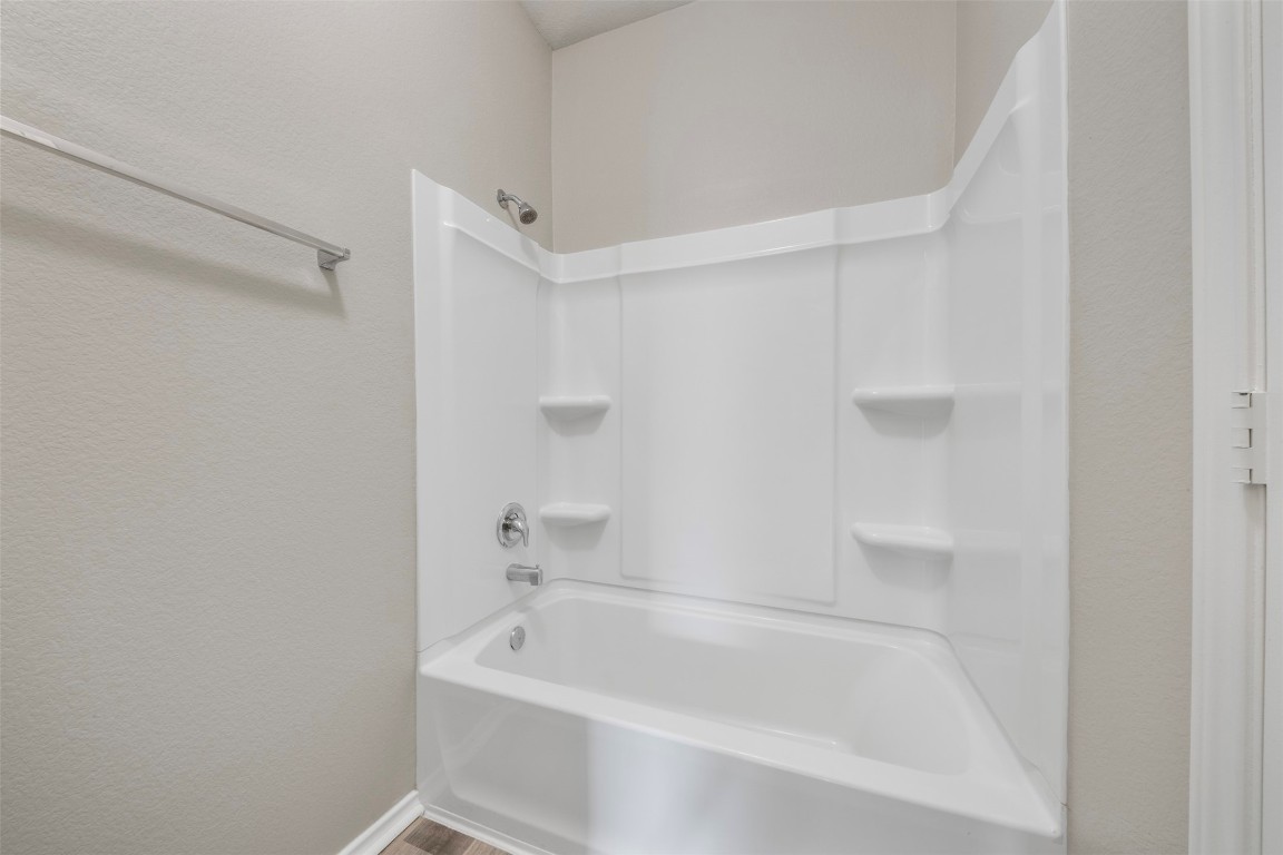 175 Courageous Side Way Magnolia, TX 77354 - Photo 21 of 28 a white bath tub sitting next to a white sink and vanity