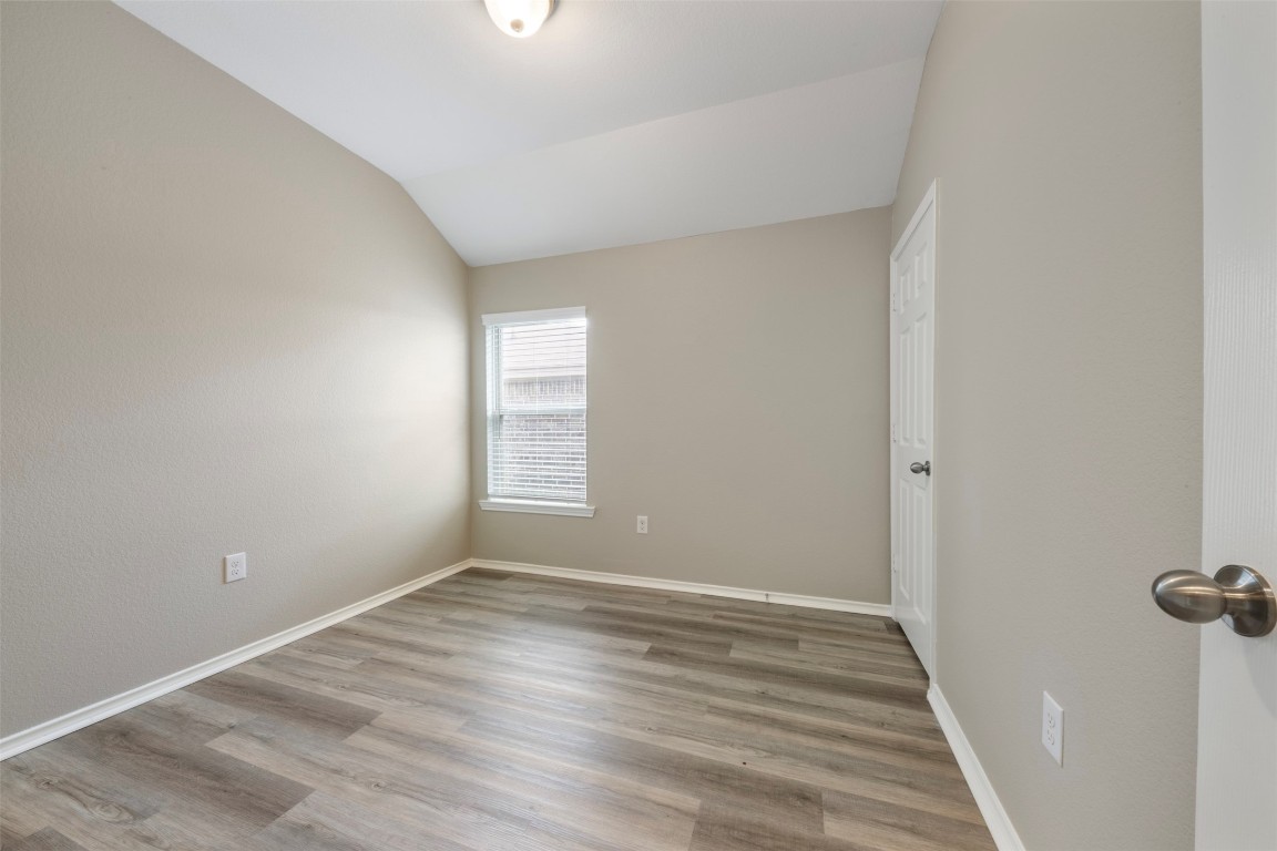 175 Courageous Side Way Magnolia, TX 77354 - Photo 23 of 28 a view of an empty room with wooden floor and a window