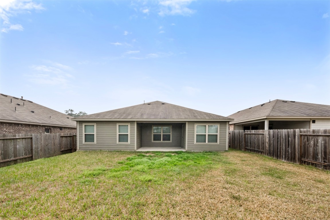 175 Courageous Side Way Magnolia, TX 77354 - Photo 27 of 28 a view of a house with a yard and wooden fence