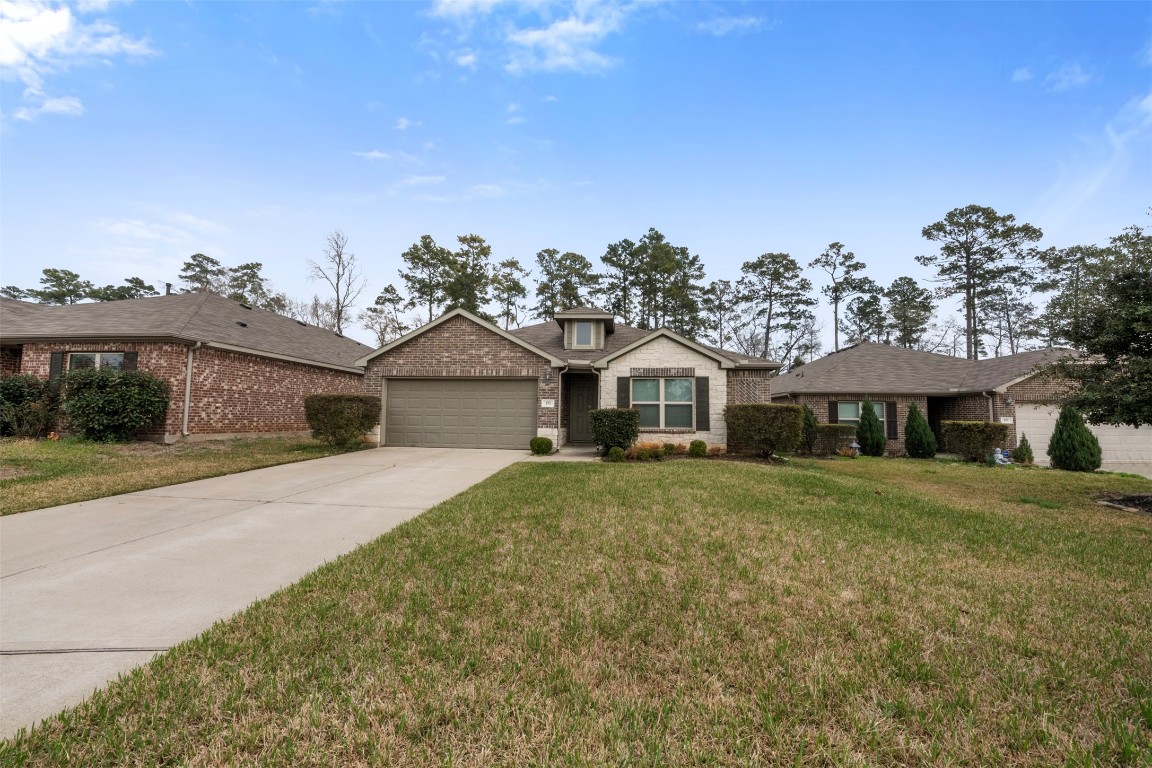 175 Courageous Side Way Magnolia, TX 77354 - Photo 28 of 28 a front view of a house with a yard