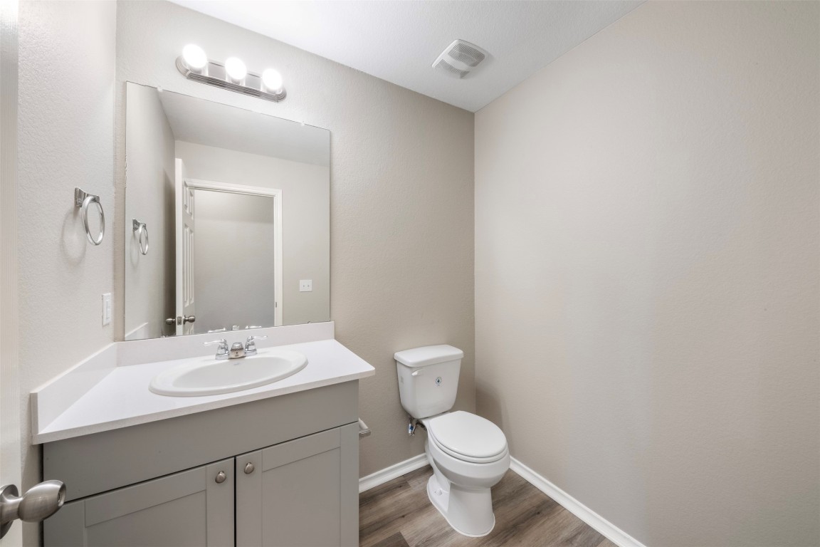 175 Courageous Side Way Magnolia, TX 77354 - Photo 4 of 28 a bathroom with a toilet a sink and mirror