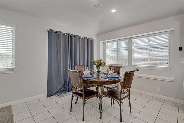 a view of a dining room with furniture and window