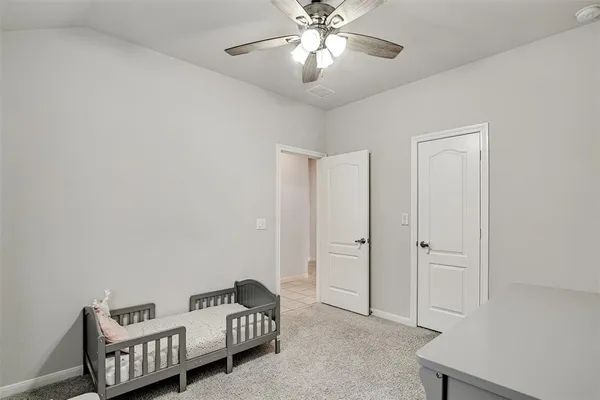 a living room with furniture and a ceiling fan
