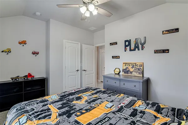 a bedroom with a bed and a dresser in it