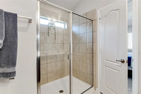 a bathroom with a glass shower door