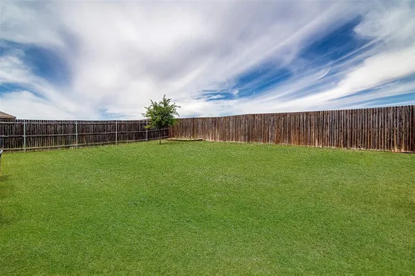 a view of yard with trampoline