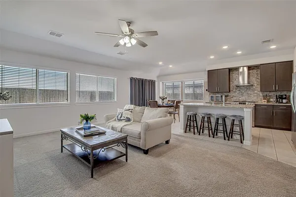 a living room with furniture and kitchen view