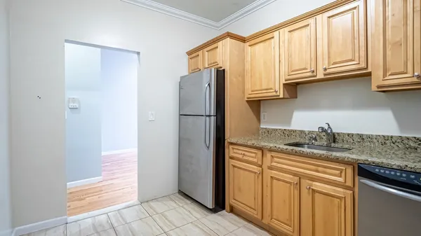 a kitchen with stainless steel appliances granite countertop a refrigerator and a sink