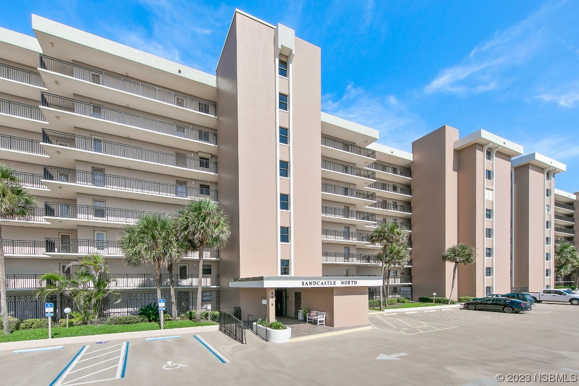 4435 South Atlantic Avenue, Unit 712 Ponce Inlet, FL 32127 - Photo 28 of 28 a front view of a building with a garden