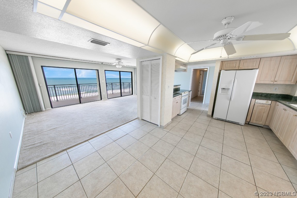 4435 South Atlantic Avenue, Unit 712 Ponce Inlet, FL 32127 - Photo 6 of 28 a view of hallway with stairs and a large window