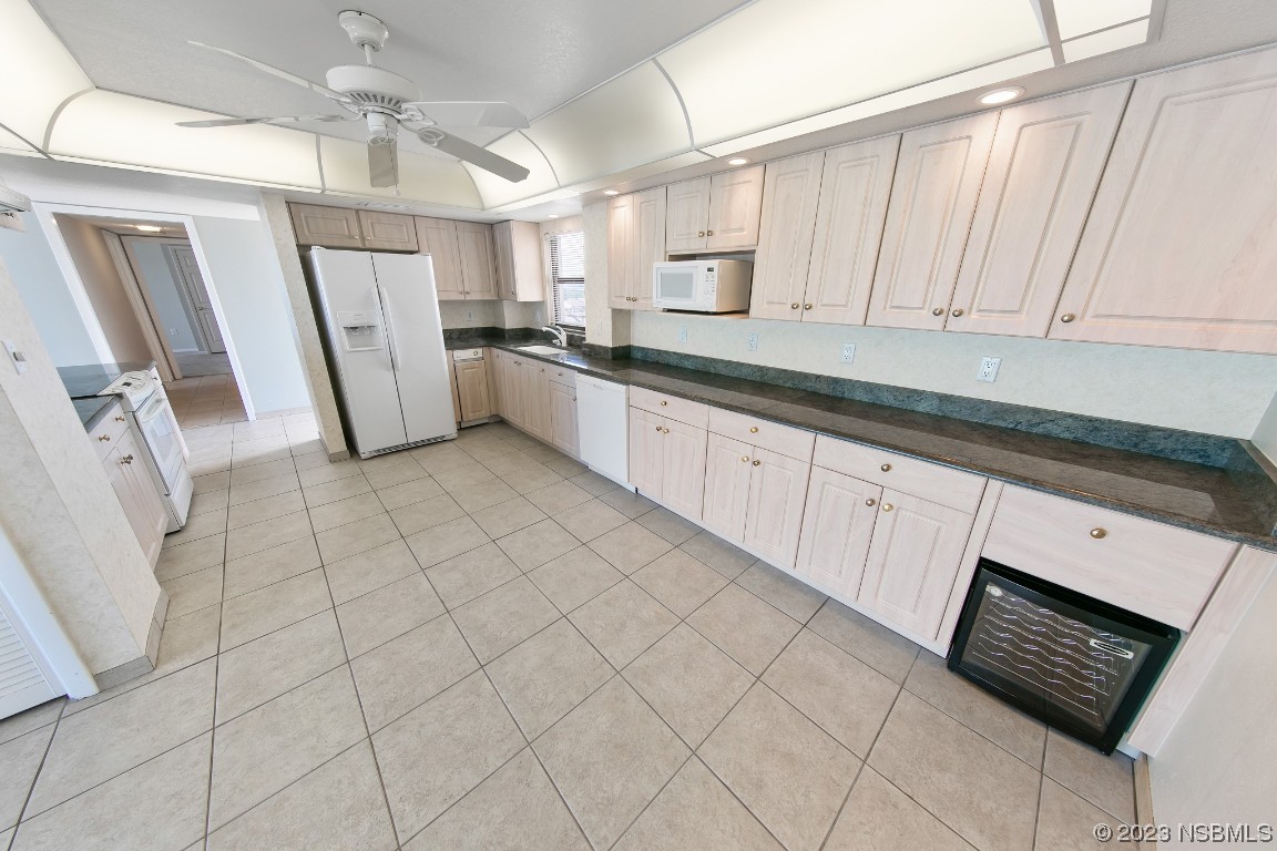 4435 South Atlantic Avenue, Unit 712 Ponce Inlet, FL 32127 - Photo 7 of 28 a large white kitchen with white cabinets