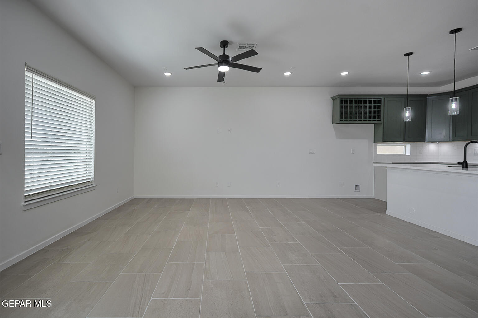 9913 Marisabel Socorro, TX 79927 - Photo 4 of 13 an empty room with wooden floor and windows