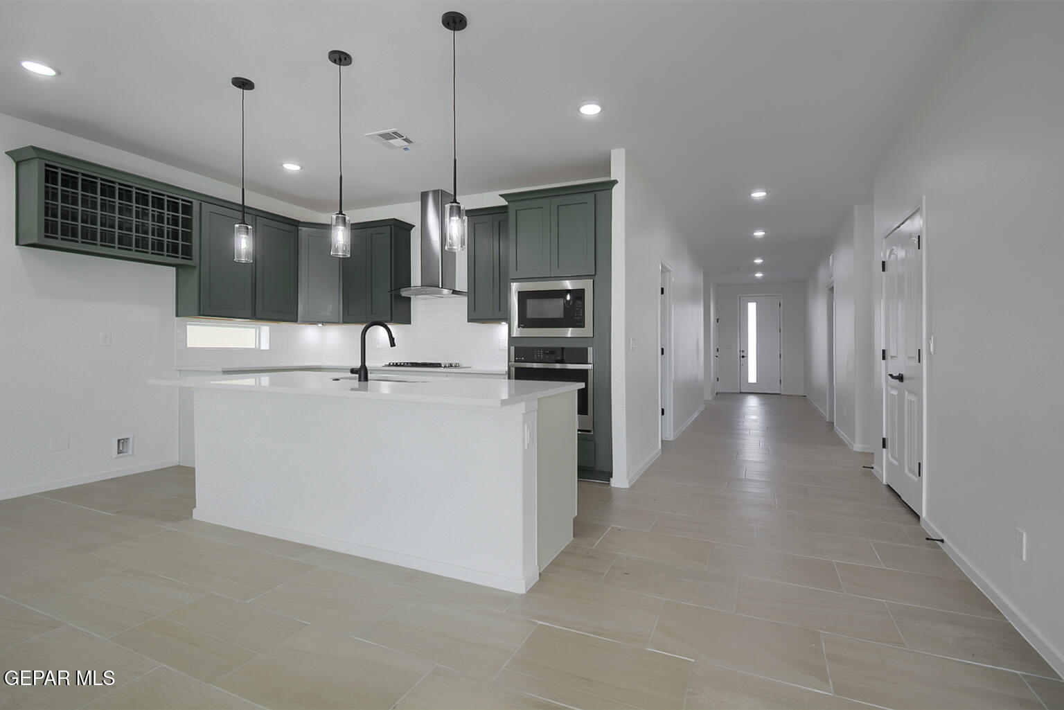 9913 Marisabel Socorro, TX 79927 - Photo 6 of 13 a view of a kitchen with a sink and a refrigerator