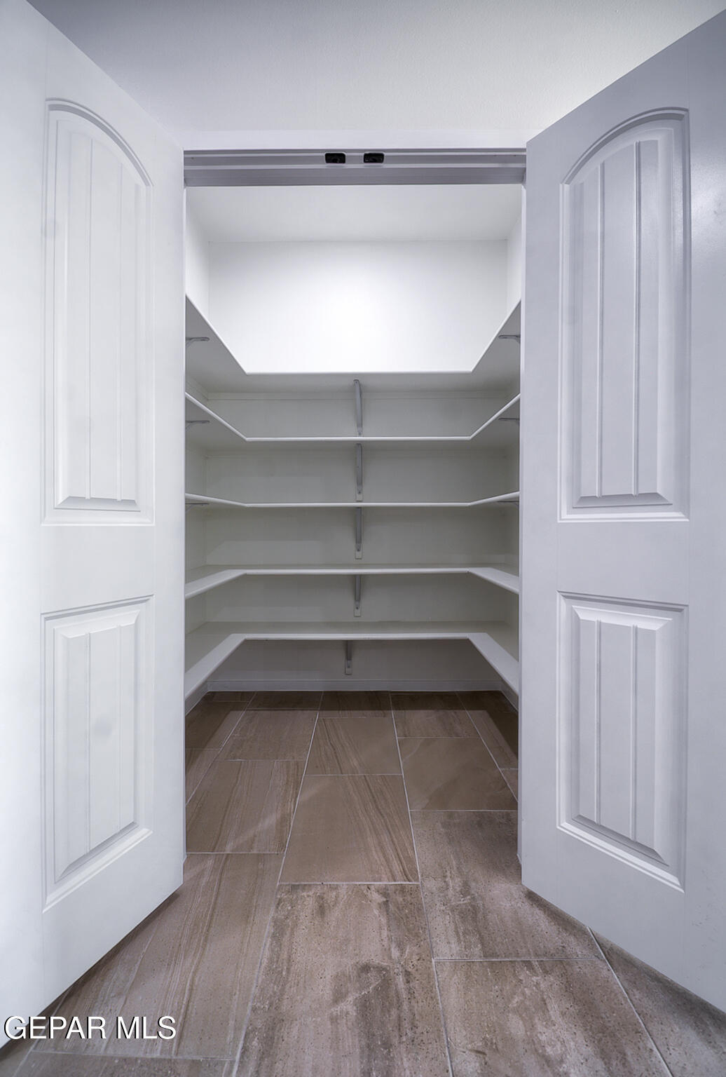 9913 Marisabel Socorro, TX 79927 - Photo 8 of 13 a view of walk in closet with empty racks