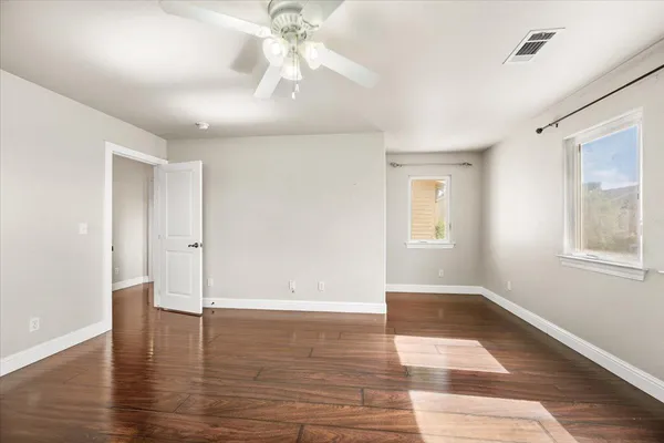 wooden floor in an empty room with a window