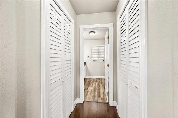 a view of a hallway with wooden floor