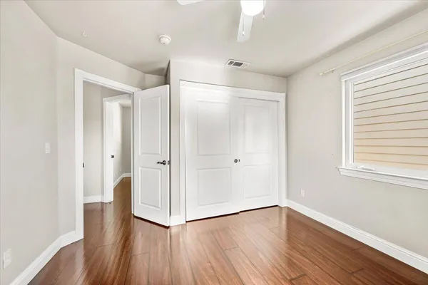an empty room with wooden floor and a window