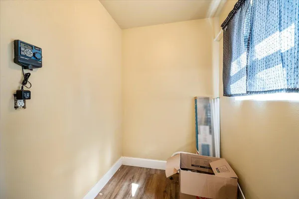 a room with a wooden floor and a window