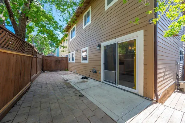 a view of backyard with cabin and wooden fence
