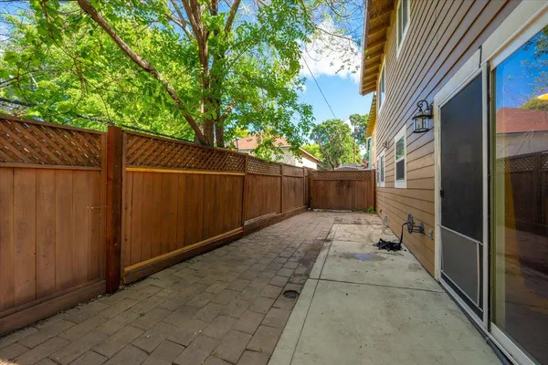a view of backyard with wooden fence