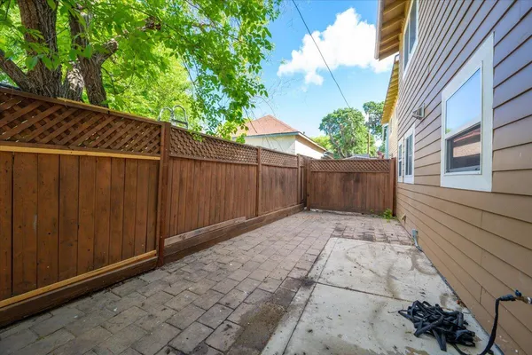 a view of backyard with wooden fence