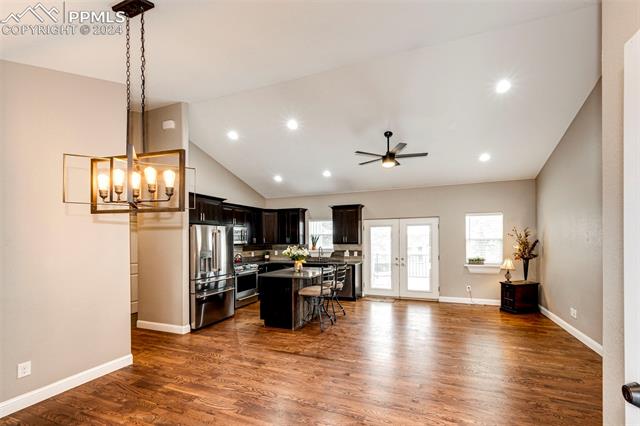 711 Pine Ridge Street Elizabeth, CO 80107 - Photo 11 of 39 Kitchen featuring pendant lighting, appliances with stainless steel finishes, dark hardwood / wood-style floors, and a breakfast bar area