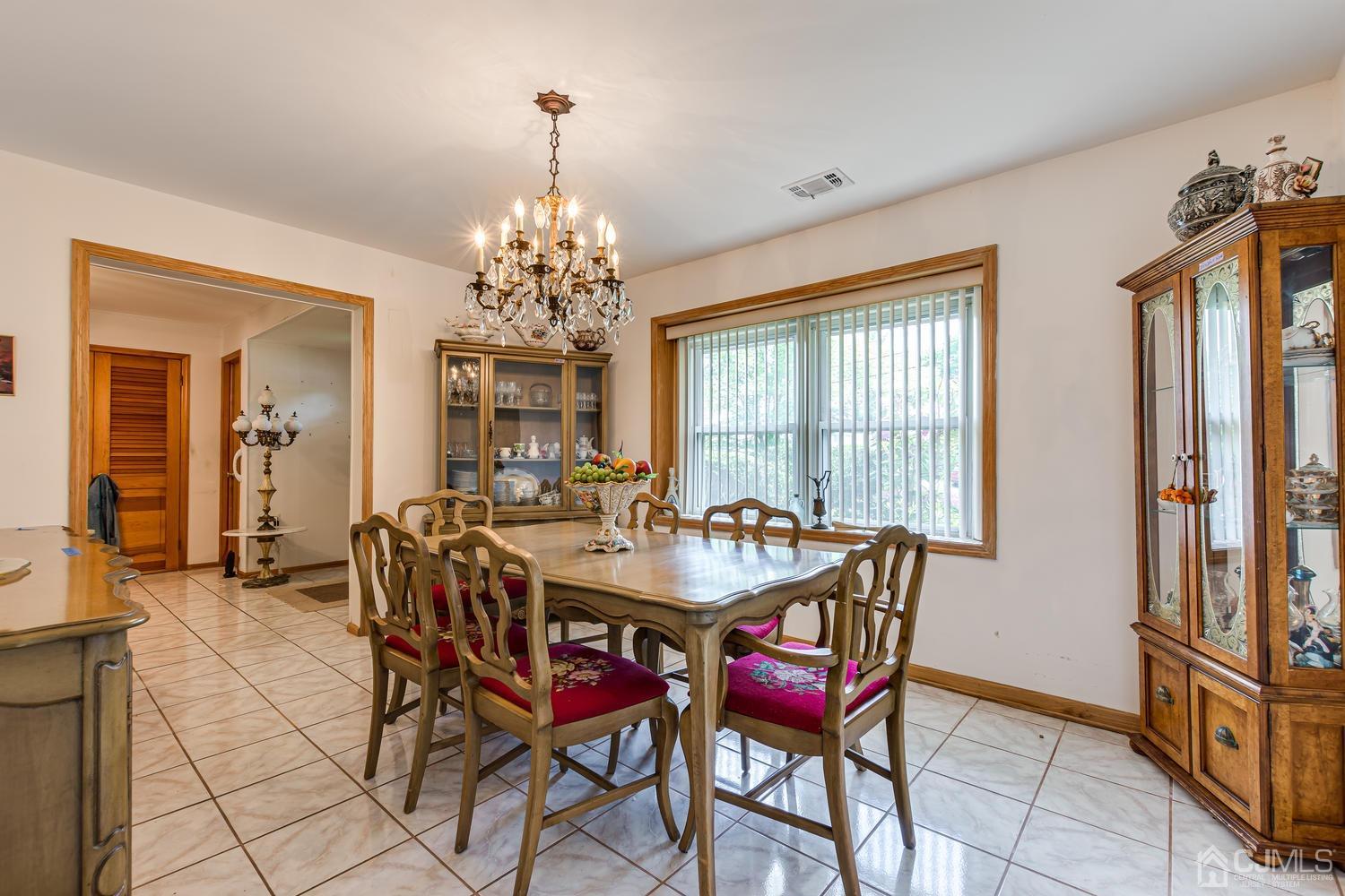 65 Drake Road Somerset, NJ 08873 - Photo 11 of 33 a dining room with furniture a chandelier and window