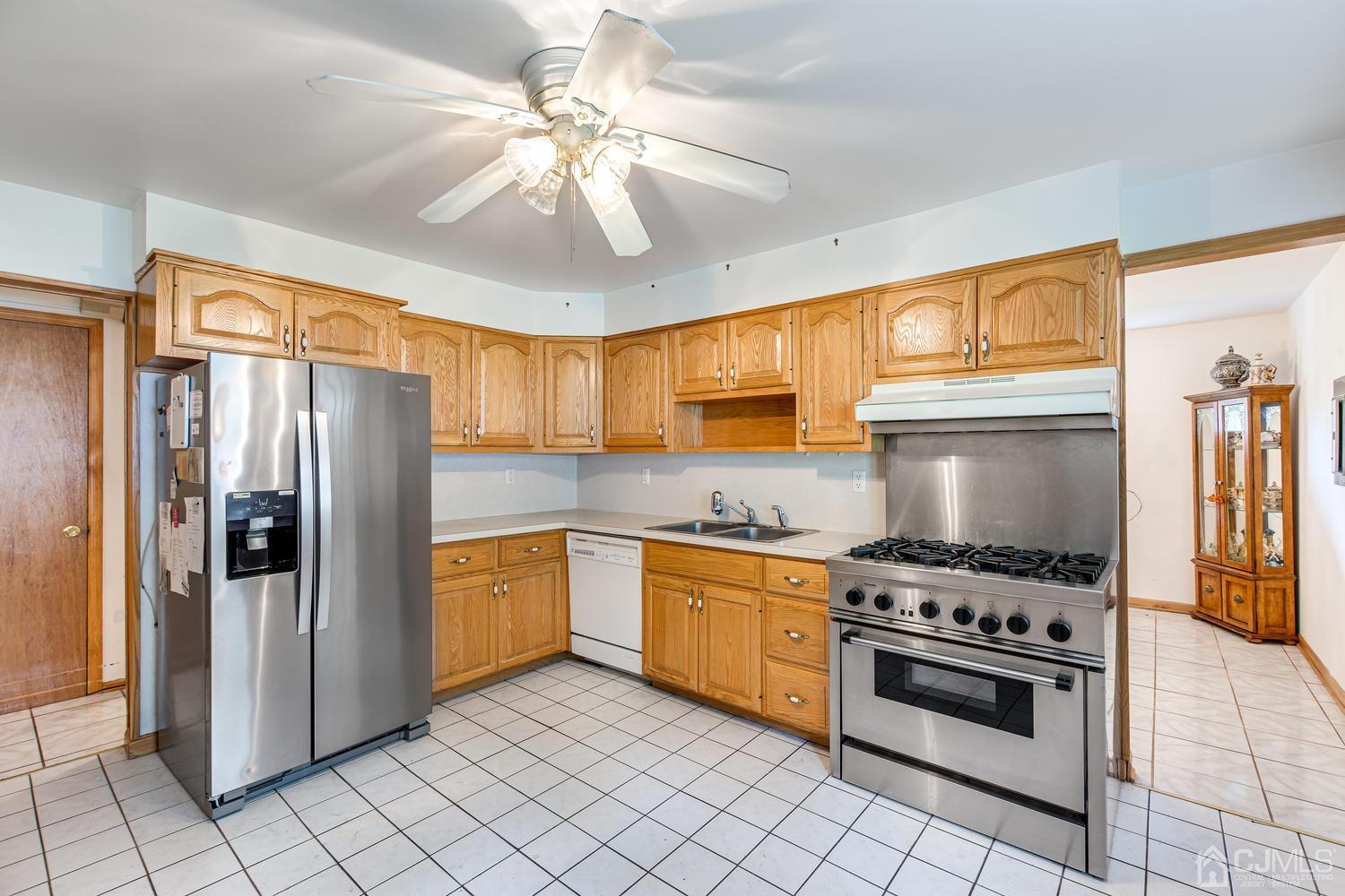 65 Drake Road Somerset, NJ 08873 - Photo 13 of 33 a kitchen with stainless steel appliances a stove a sink and a refrigerator