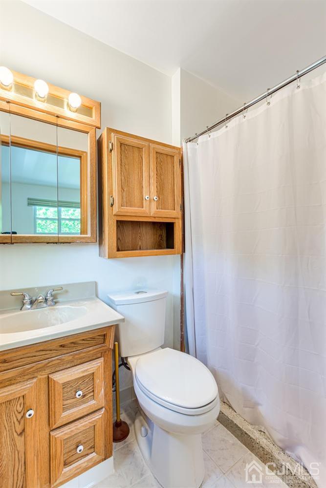 65 Drake Road Somerset, NJ 08873 - Photo 21 of 33 a bathroom with a sink a toilet and shower curtain