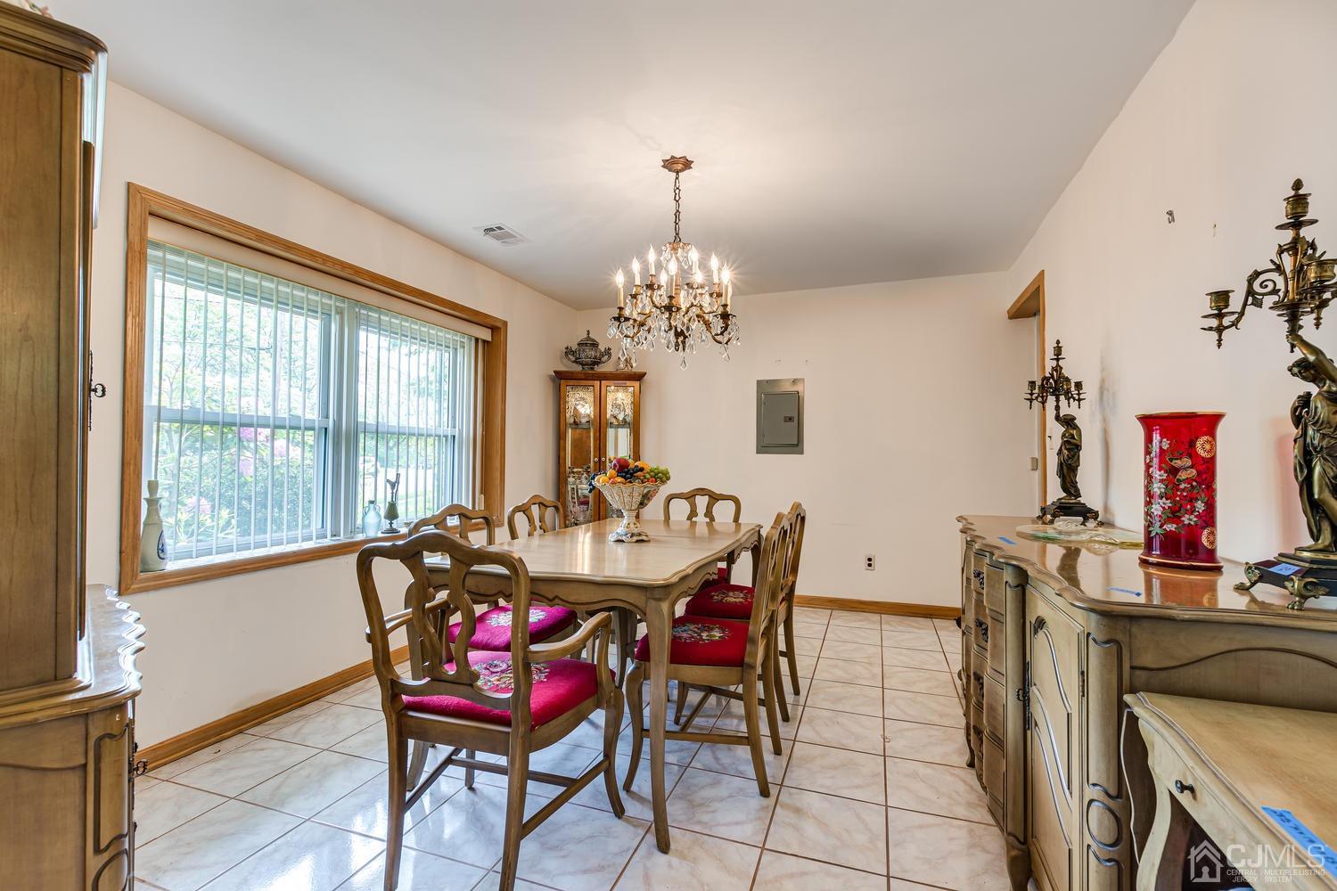 65 Drake Road Somerset, NJ 08873 - Photo 10 of 33 a dining room with furniture a chandelier and wooden floor