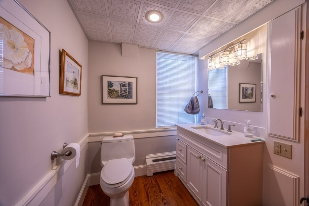 164 Main Street Fairhaven, MA 02719 - Photo 13 of 42 a bathroom with a toilet sink and mirror