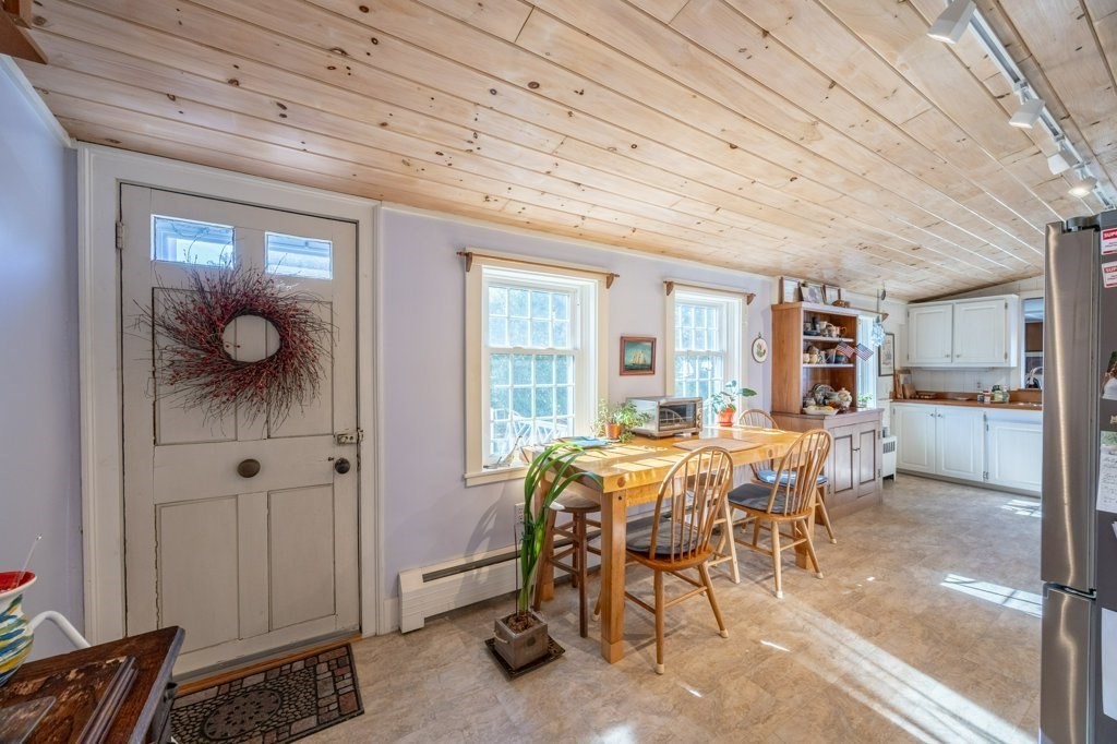 164 Main Street Fairhaven, MA 02719 - Photo 14 of 42 a view of a dining room with furniture and chandelier