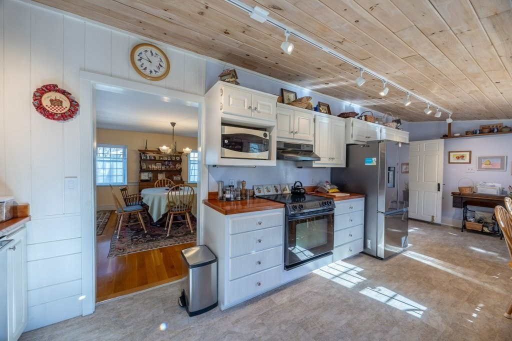 164 Main Street Fairhaven, MA 02719 - Photo 15 of 42 a kitchen with stainless steel appliances kitchen island granite countertop a stove and a sink