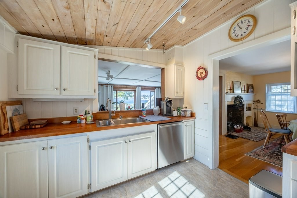 164 Main Street Fairhaven, MA 02719 - Photo 17 of 42 a kitchen with stainless steel appliances granite countertop a sink and cabinets