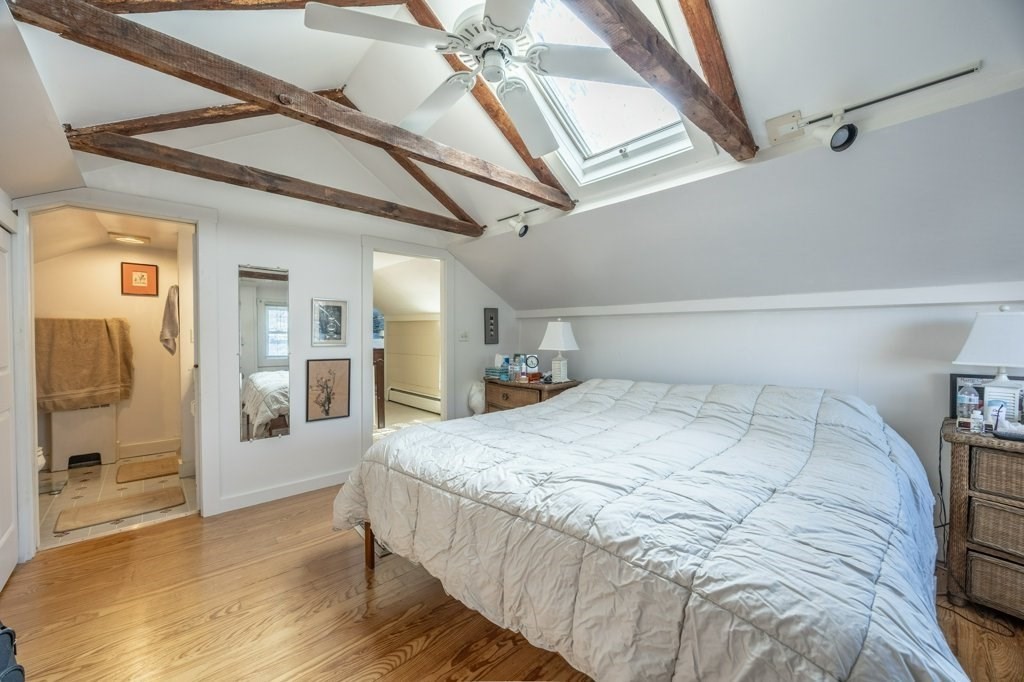 164 Main Street Fairhaven, MA 02719 - Photo 29 of 42 a bedroom with a large bed and wooden floor