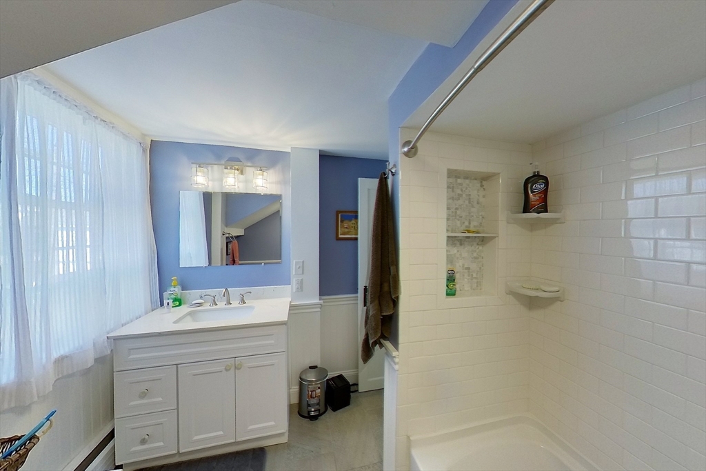 164 Main Street Fairhaven, MA 02719 - Photo 32 of 42 a bathroom with a sink a mirror and shower