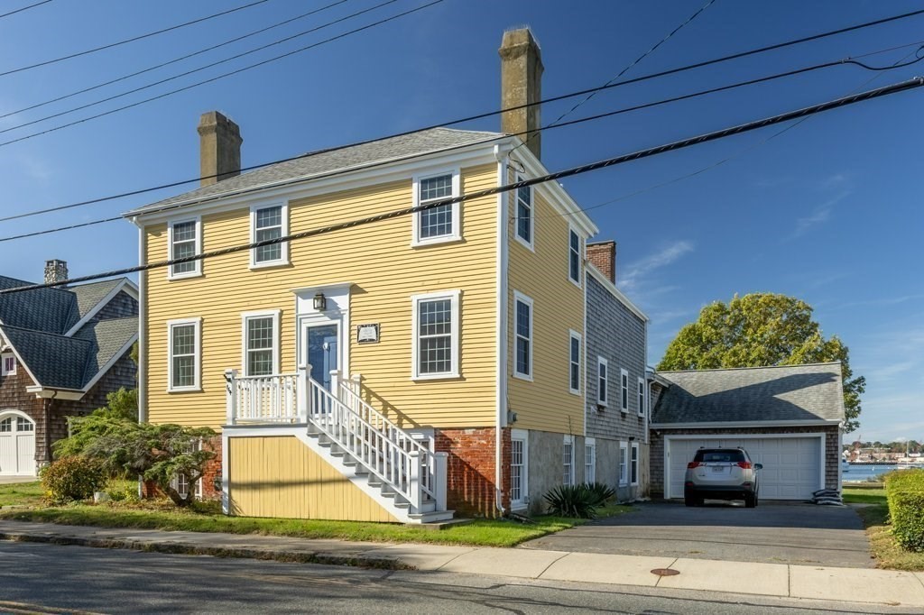164 Main Street Fairhaven, MA 02719 - Photo 4 of 42 a front view of a house with a garden