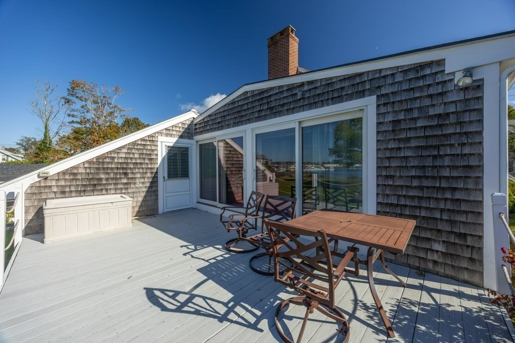 164 Main Street Fairhaven, MA 02719 - Photo 7 of 42 a view of a patio with table and chairs with wooden floor and fence