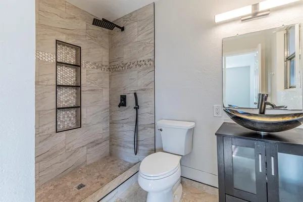 a bathroom with a sink toilet and shower