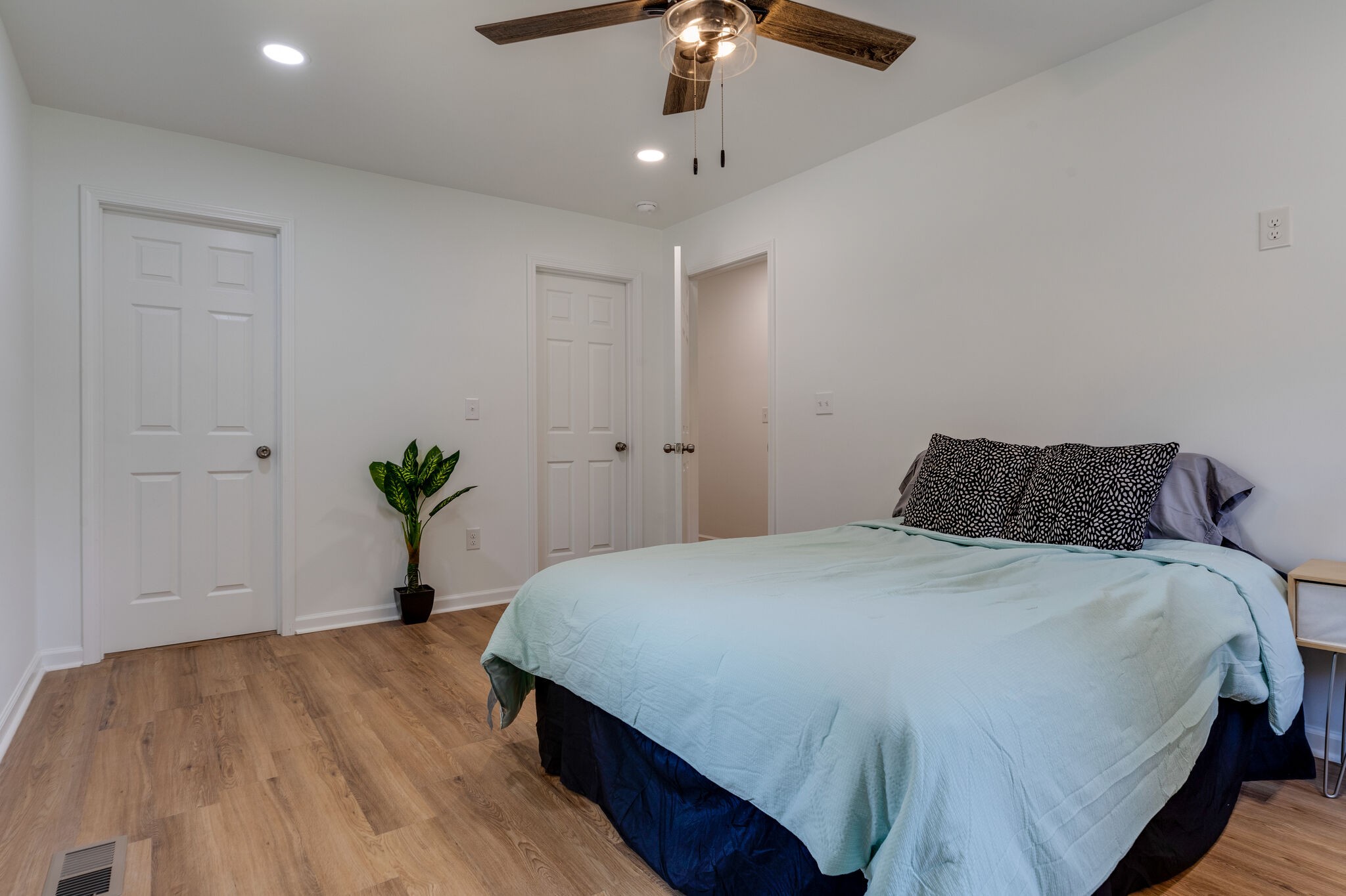 200 Shady Hill Road Dickson, TN 37055 - Photo 24 of 34 a spacious bedroom with a bed and a potted plant